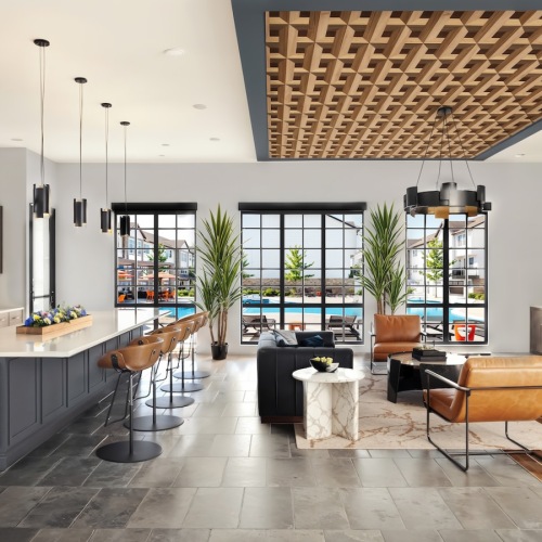 a clubhouse with a kitchen, seating, tables and a tv