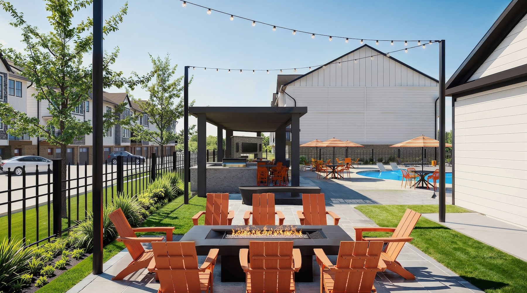 a patio area with a fire pit and chairs