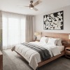 a bed in a room with a large window and a desk