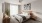 a bedroom with a bed and a plant